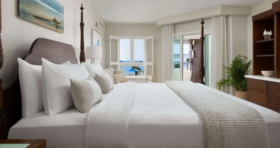 Beachfront club room with four-poster king bed and ocean view at Sandals South Coast.