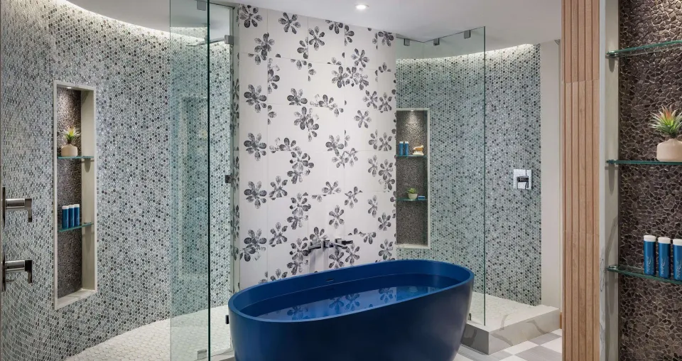 Beachfront club room bathroom with blue soaking tub at Sandals South Coast.
