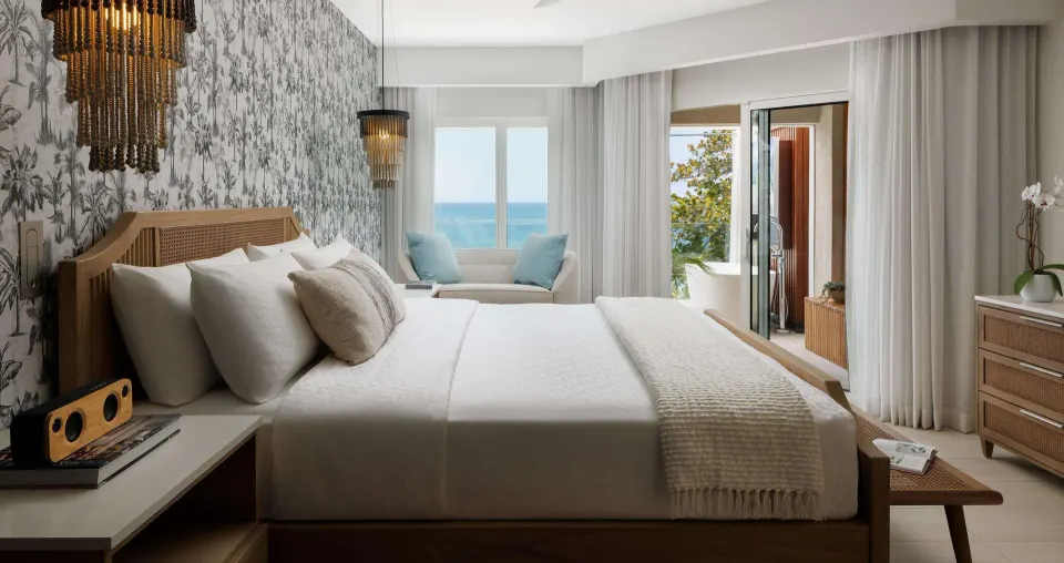 Beachfront club room king bed with ocean view and patio tub at Sandals South Coast.