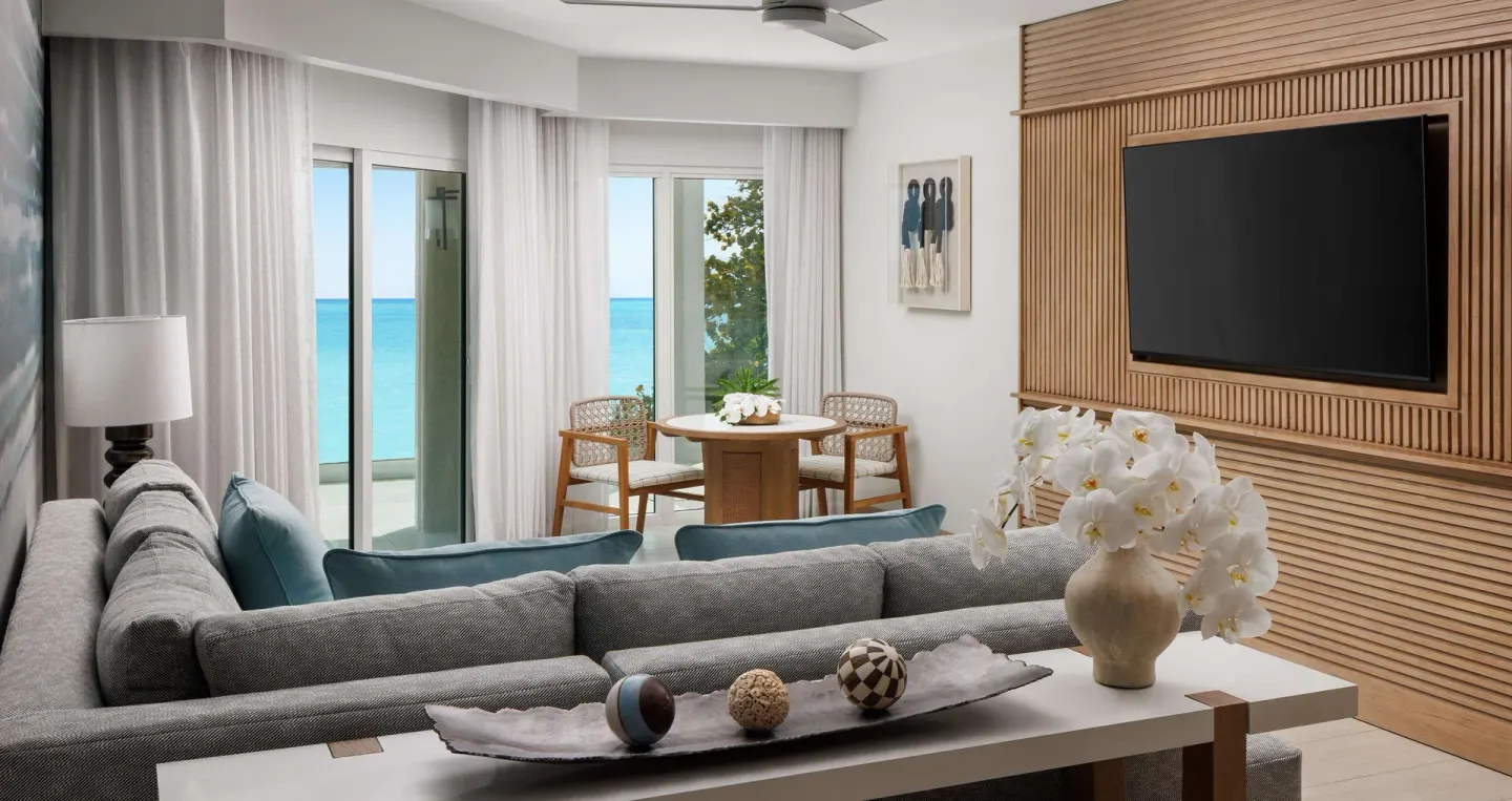 Beachfront club room sitting area with ocean-facing doors at Sandals South Coast.