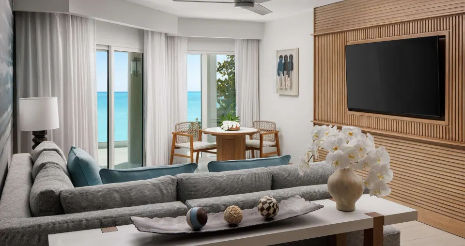 Beachfront club room sitting area with ocean-facing doors at Sandals South Coast.