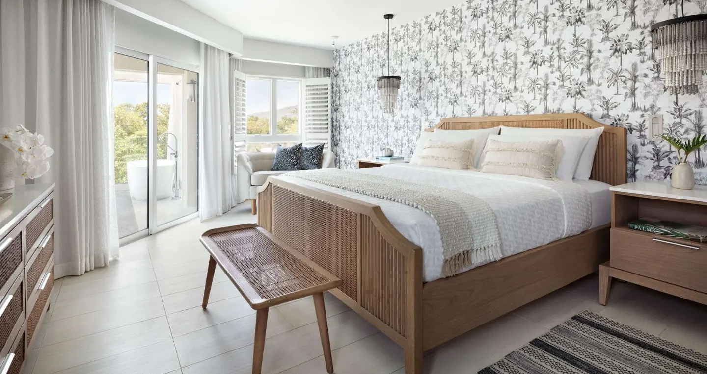 Beachfront club suite bedroom with king bed and balcony at Sandals South Coast.