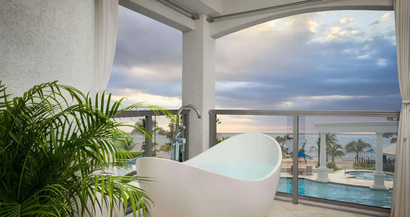 Beachfront balcony soaking tub with ocean view at Sandals South Coast.