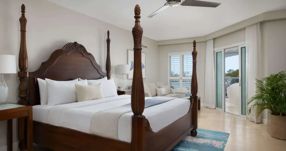 Club suite king bed with balcony soaking tub at Sandals South Coast.