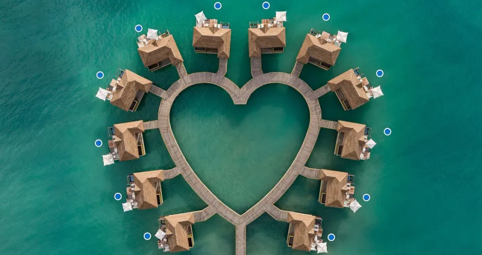 Aerial view of overwater villas in a heart shape at Sandals South Coast.