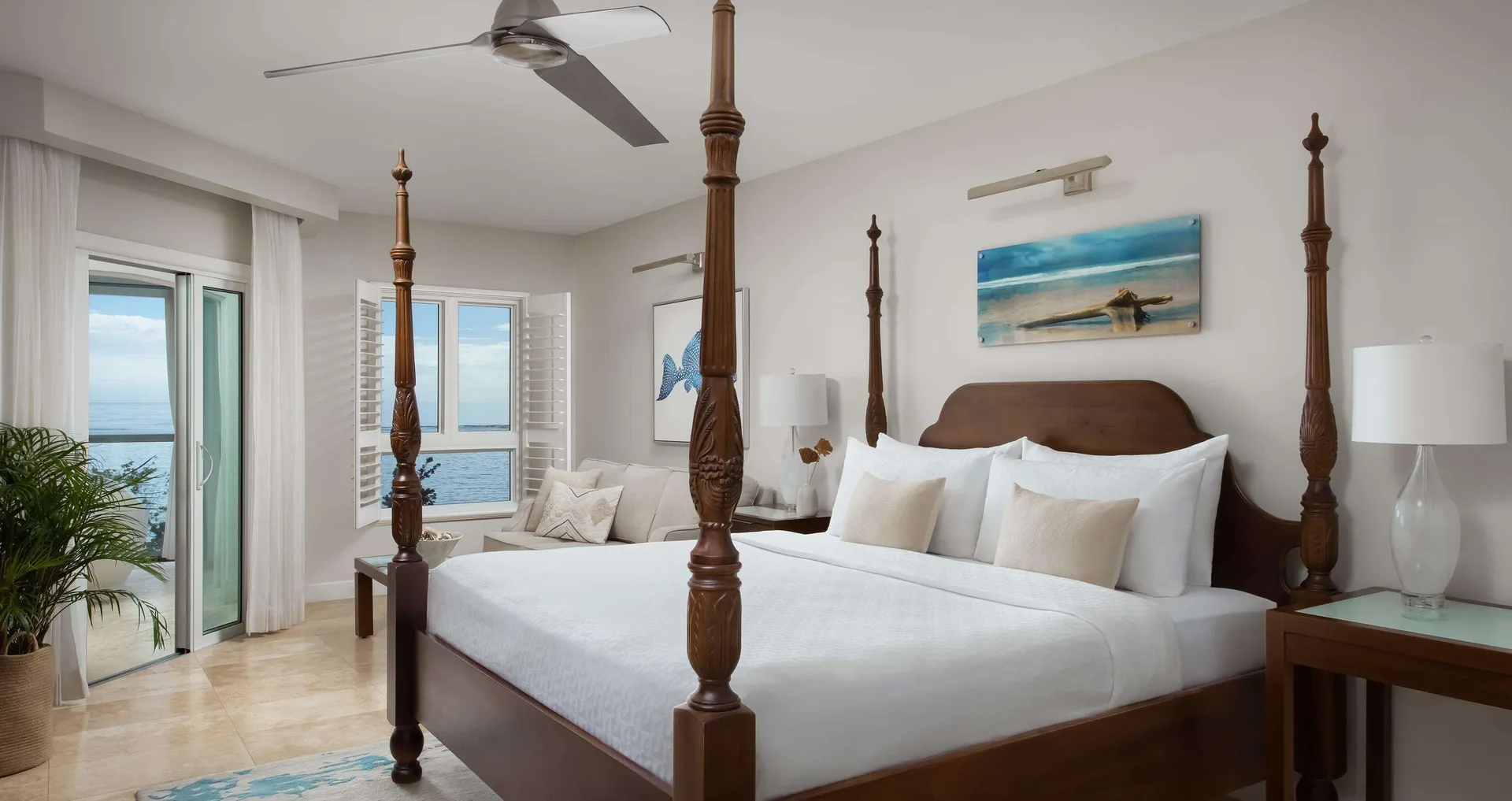 Four-poster king bed in an ocean-view honeymoon room at Sandals South Coast.