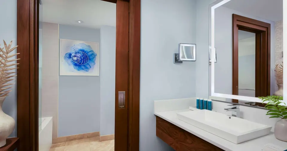 Junior suite bathroom vanity with lit mirror at Sandals South Coast.