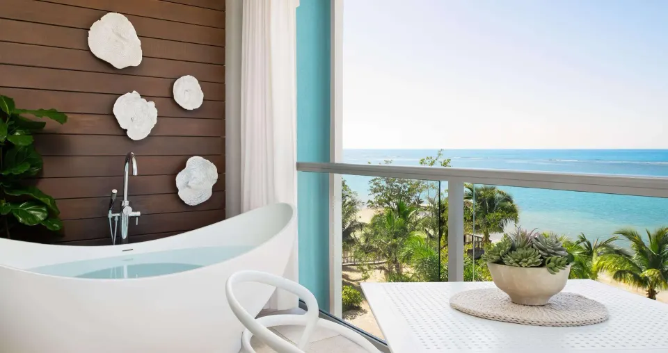 Suite balcony soaking tub and beachfront view at Sandals South Coast.