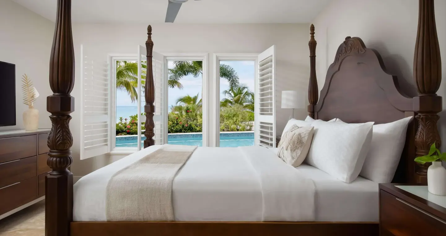 Four-poster king bedroom with pool and ocean views at Sandals South Coast.