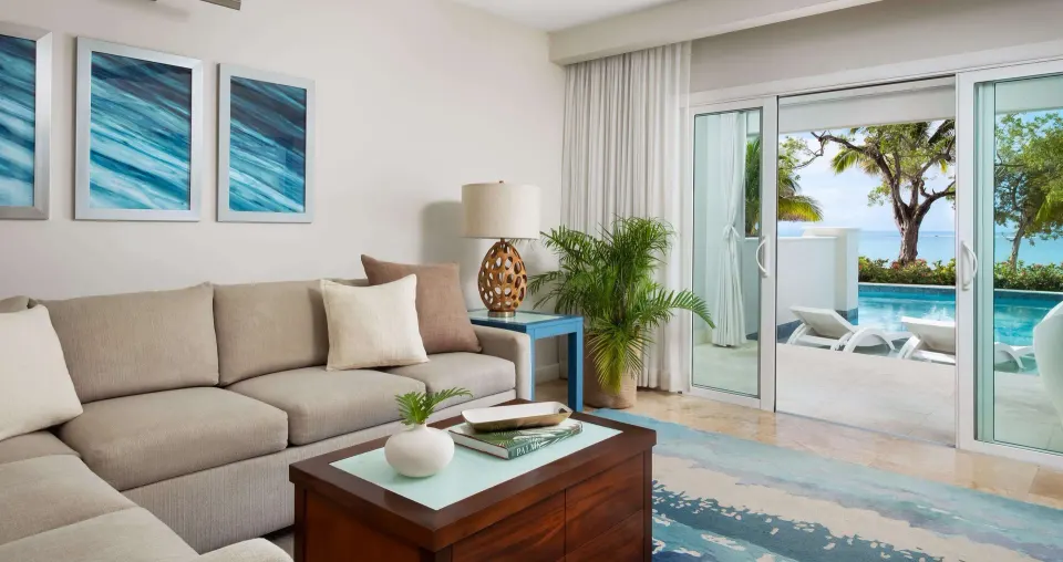 Beachfront suite living room with sliding doors to the swim-up pool at Sandals South Coast.
