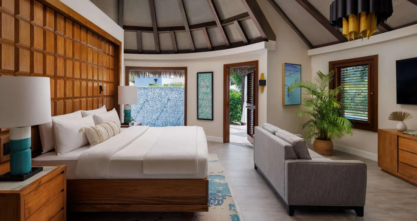 Rondoval villa king bed and sitting area at Sandals South Coast.