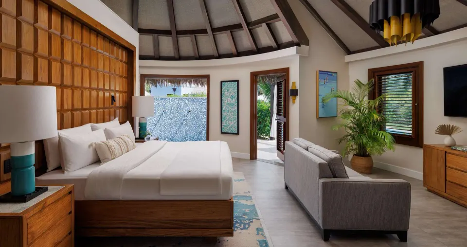 Rondoval villa king bed and sitting area at Sandals South Coast.