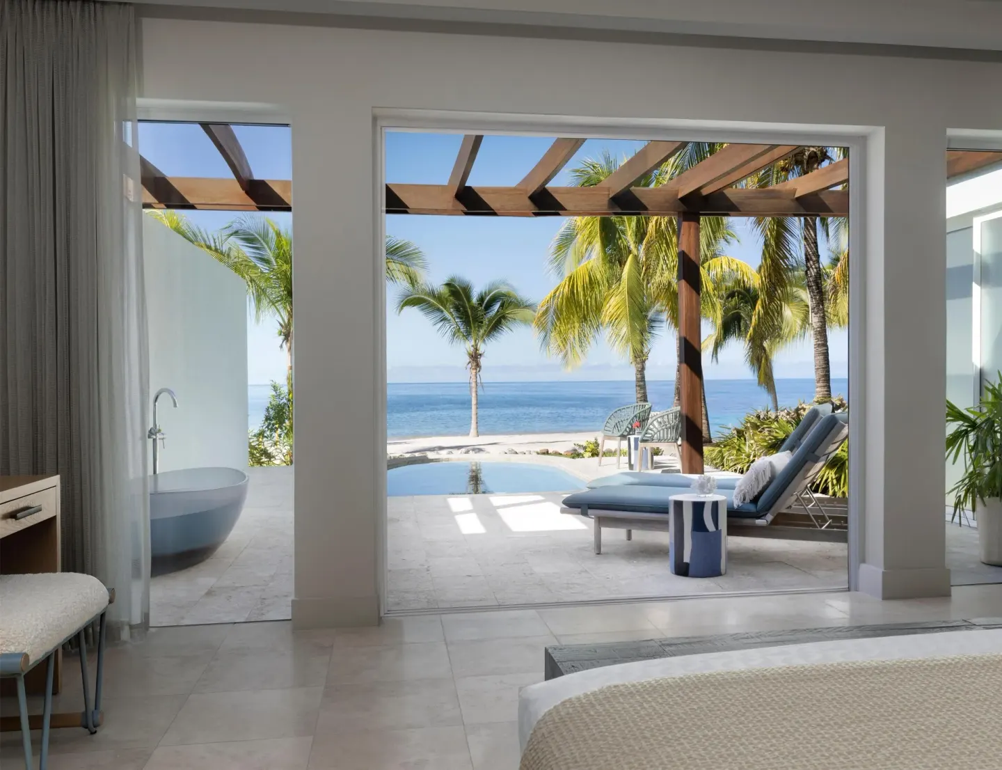 Guest room opens to a private pool terrace and ocean view at Sandals St. Vincent and the Grenadines.