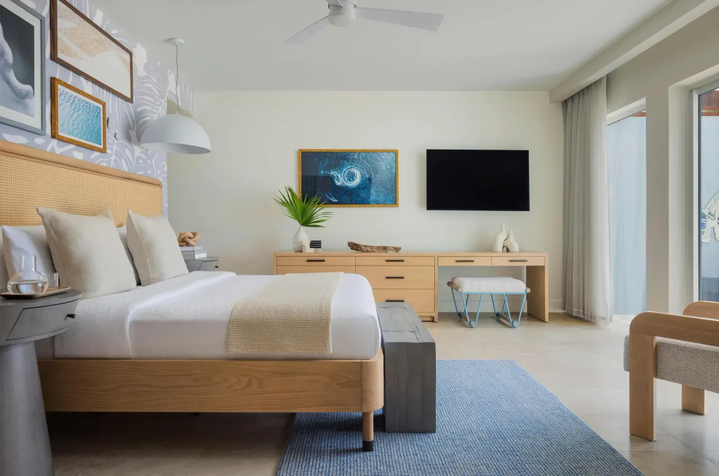 Bright king bedroom with desk and seating at Sandals St. Vincent and the Grenadines.