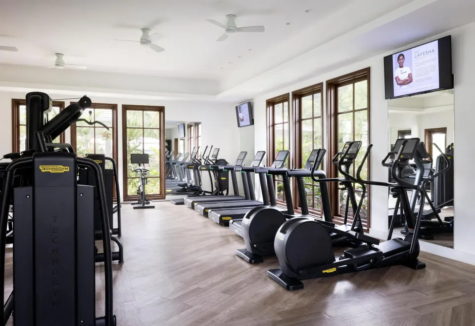 Fitness center with cardio machines and mirrors at Sandals St. Vincent and the Grenadines.