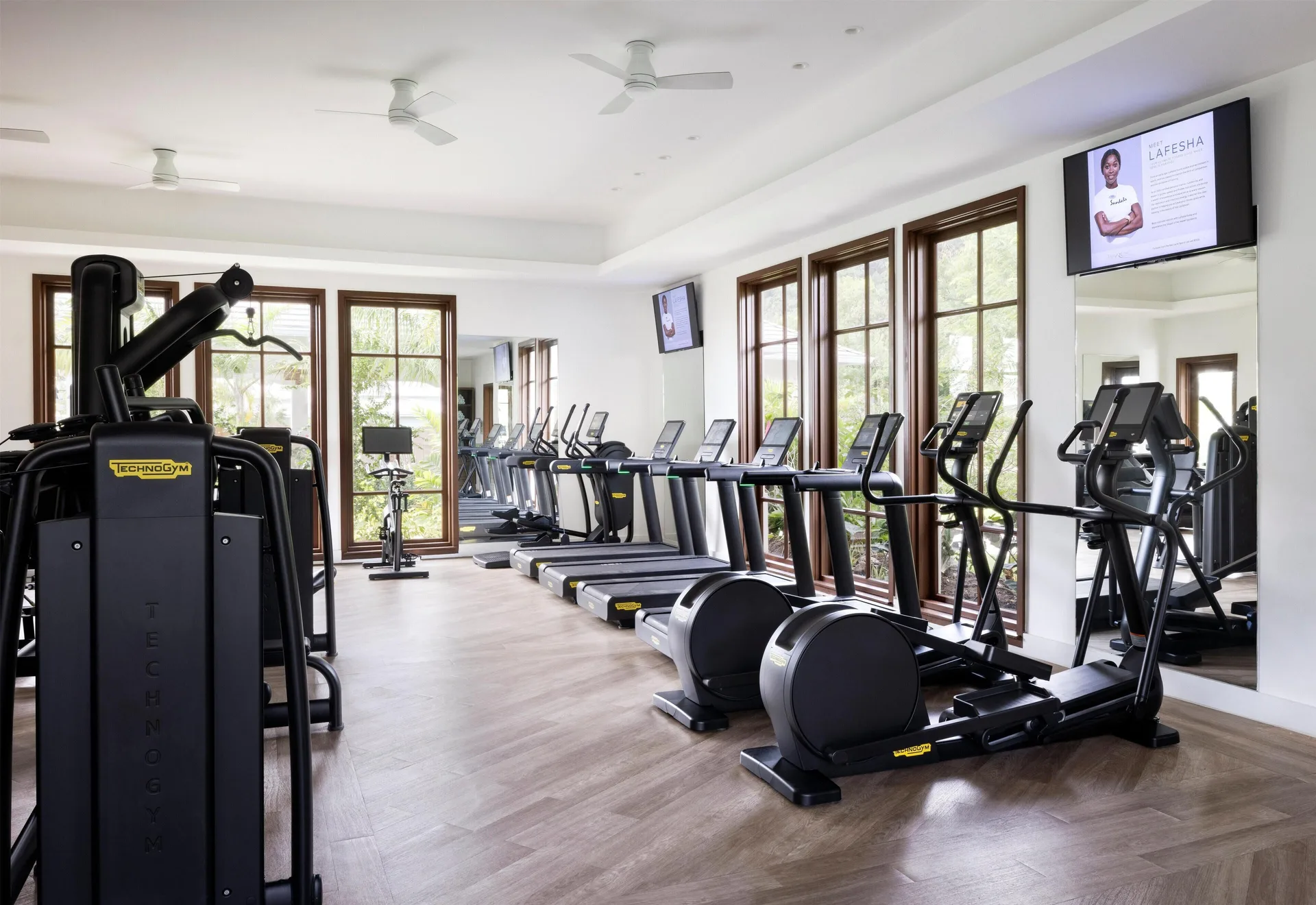 Fitness center with cardio machines and mirrors at Sandals St. Vincent and the Grenadines.