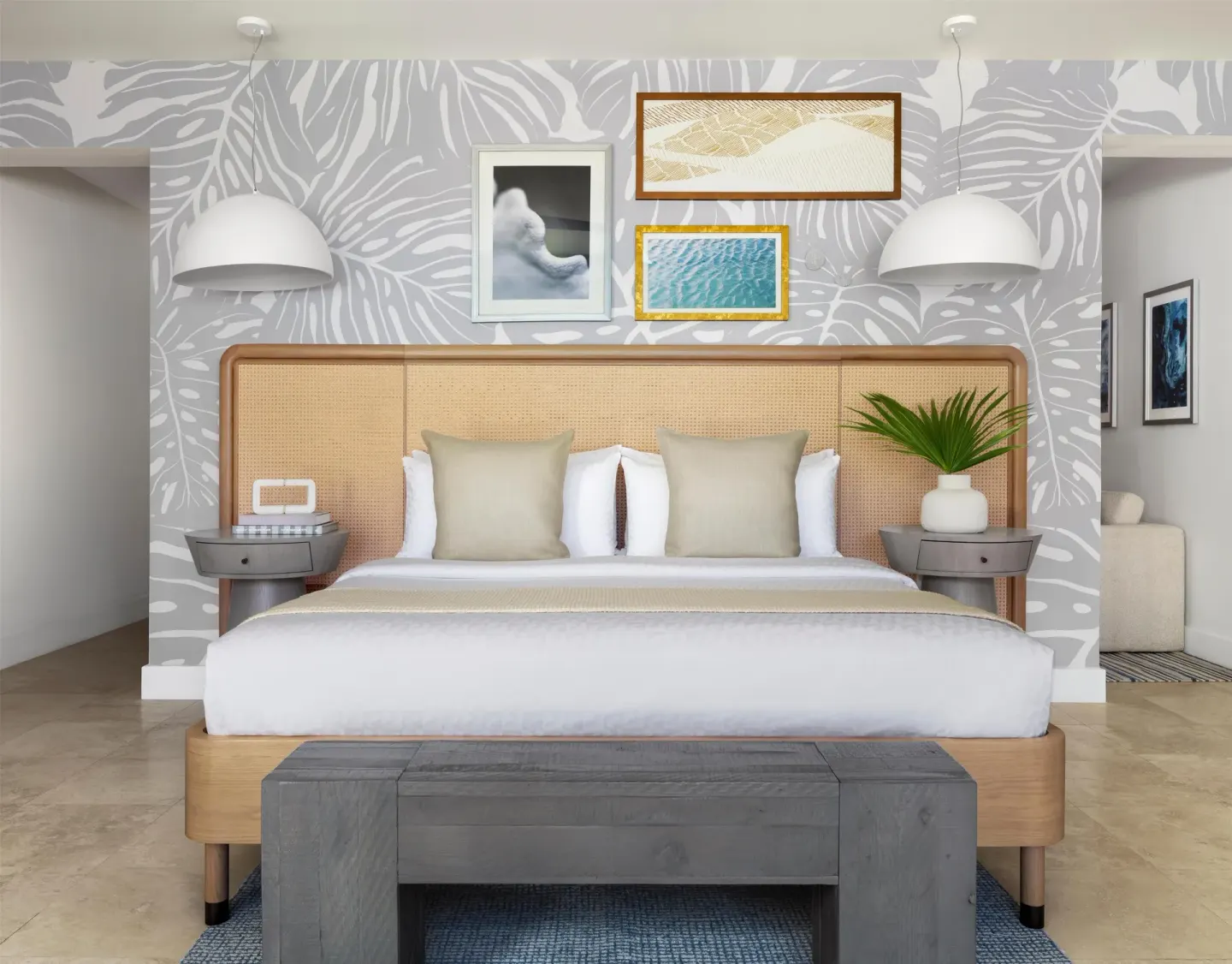 Centered king bed with leaf-patterned wall and pendant lamps at Sandals St. Vincent and the Grenadines.