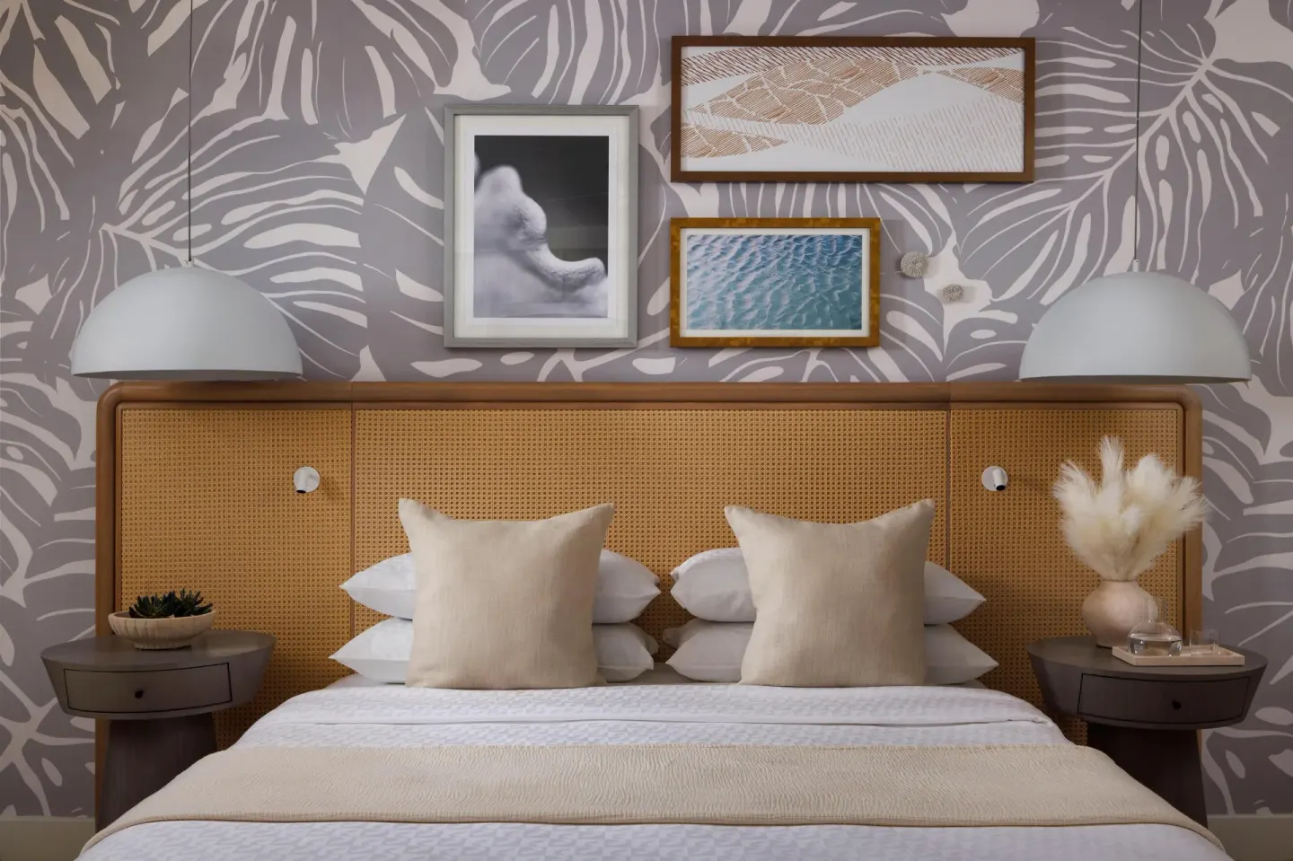 King bed headboard with pendant lights and framed art at Sandals St. Vincent and the Grenadines.