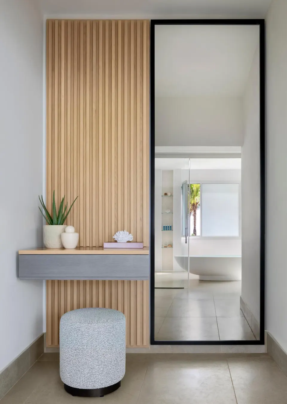 Guest room vanity and mirror facing a bathtub at Sandals St. Vincent and the Grenadines.
