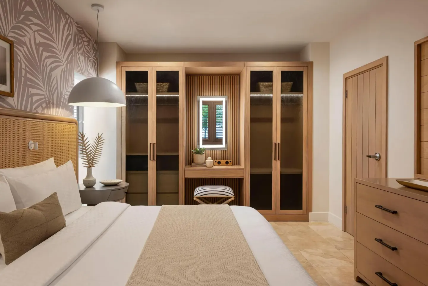 King bedroom with wardrobes and vanity nook at Sandals St. Vincent and the Grenadines.