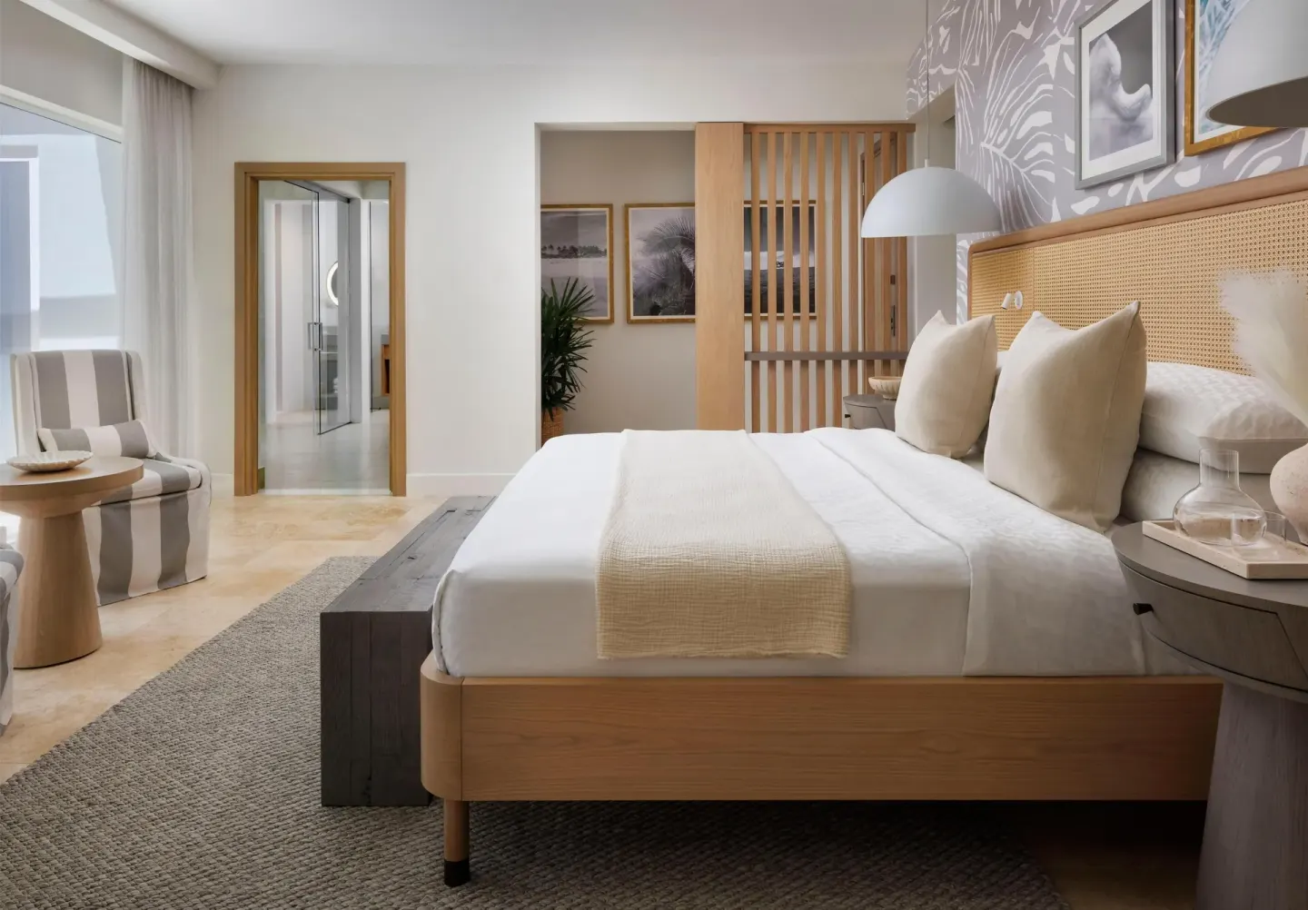 King bedroom with sitting chair and open bathroom doorway at Sandals St. Vincent and the Grenadines.