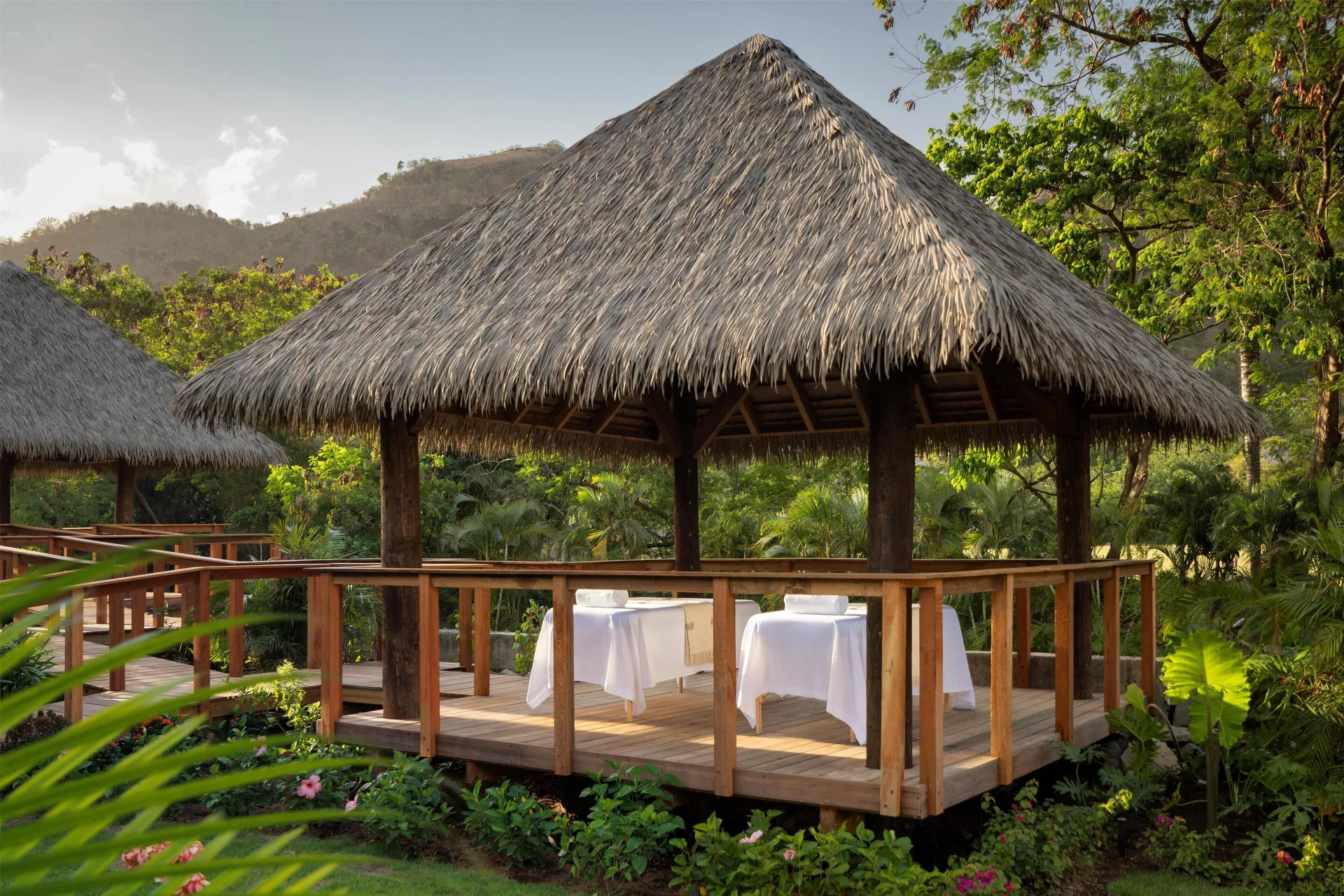 Thatched spa pavilion with massage tables at Sandals St. Vincent and the Grenadines.