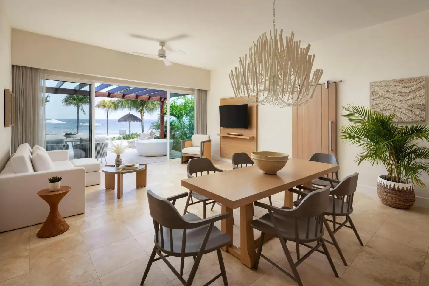 Villa living and dining room with ocean-facing patio at Sandals St. Vincent and the Grenadines.