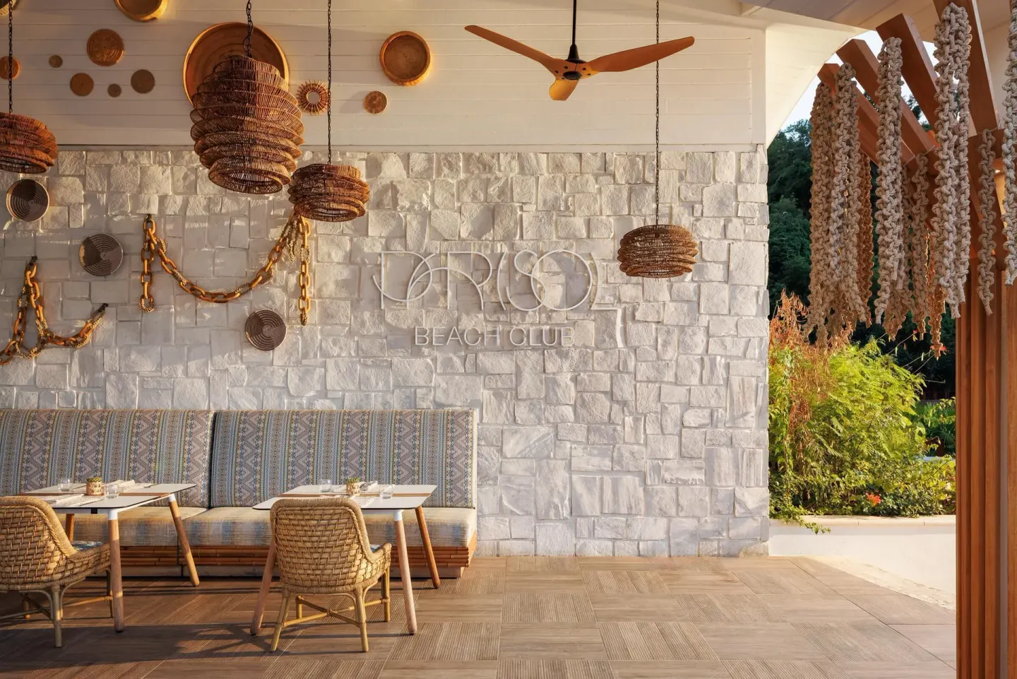 Parisol Beach Club seating and stone wall at Sandals St. Vincent and the Grenadines.