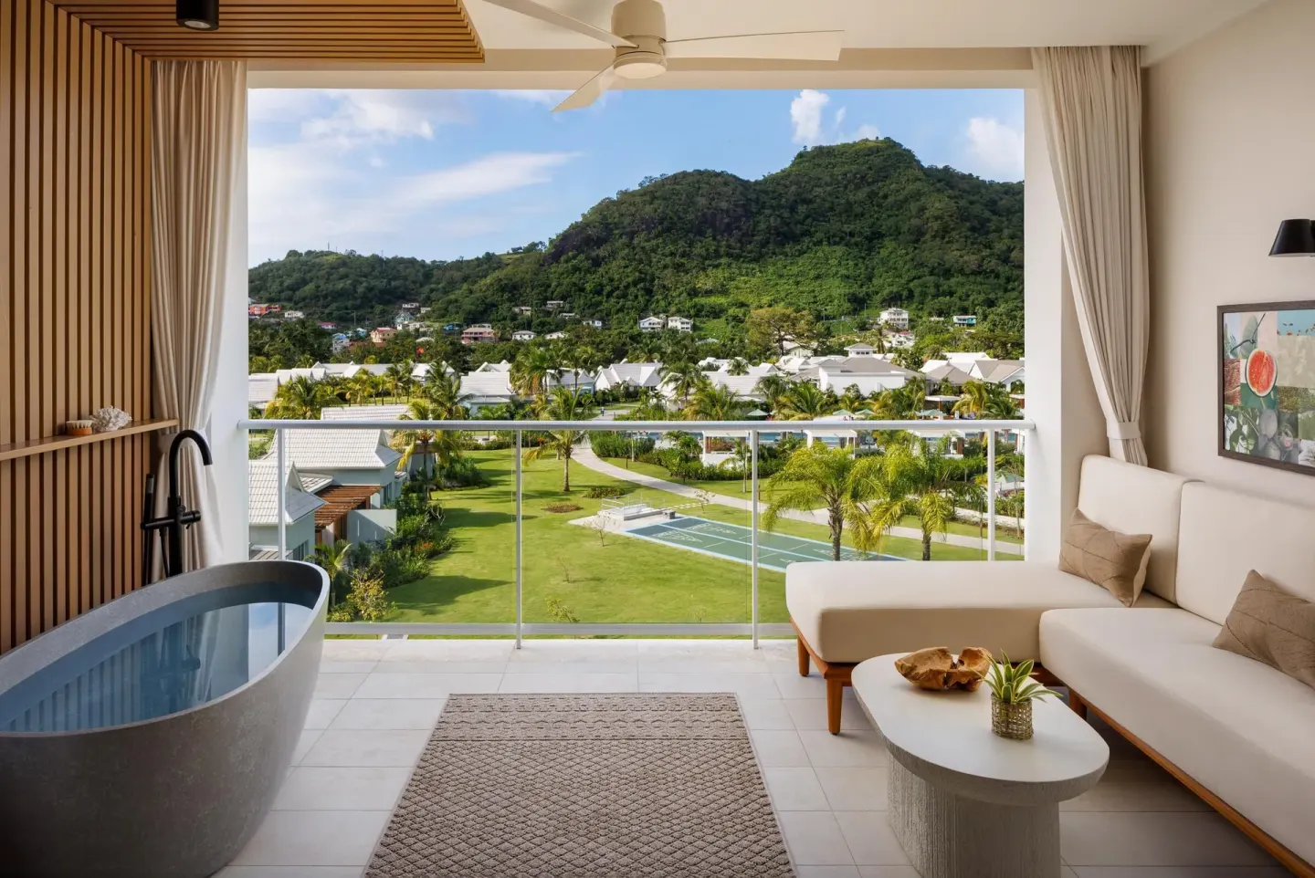 Balcony soaking tub and sofa in a Bamboo Palm room at Sandals St. Vincent and the Grenadines.