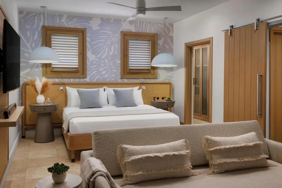 Garden Butler Suite king bed and sofa seating at Sandals St. Vincent and the Grenadines.