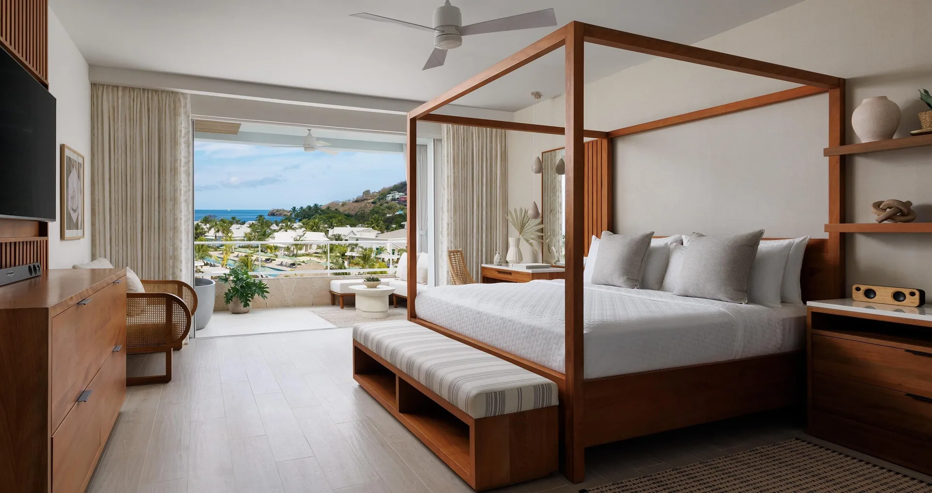 Lady Palm Partial Oceanview Club Suite with king bed, balcony, and partial ocean views at Sandals St. Vincent and the Grenadines.