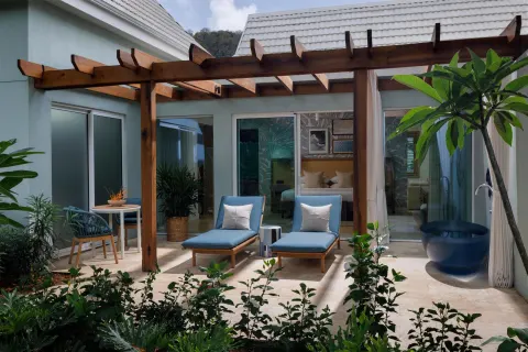 Garden suite patio with loungers and soaking tub at Sandals St. Vincent and the Grenadines.