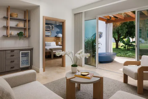 Garden Butler Suite living area and patio soaking tub at Sandals St. Vincent and the Grenadines.