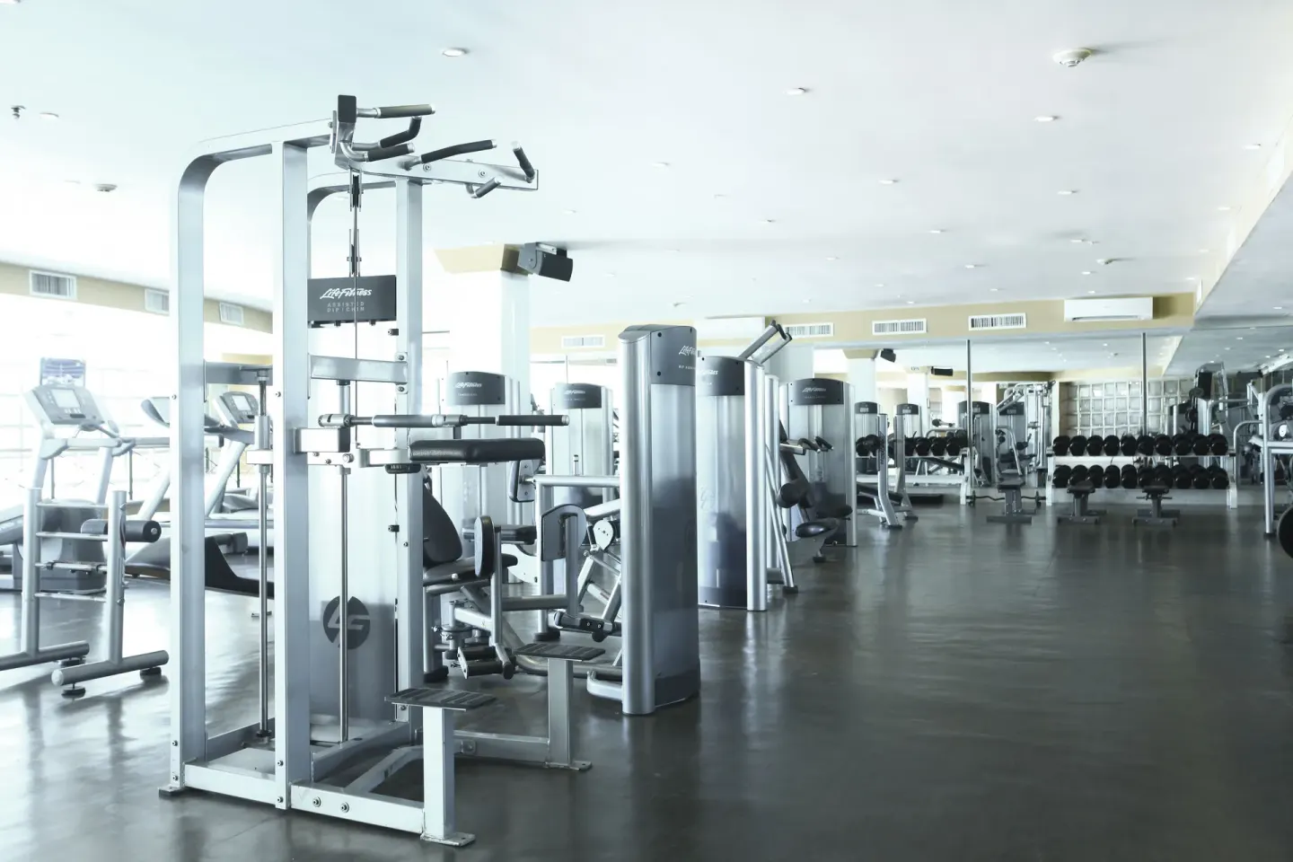 Fitness center with cardio and strength equipment at Sandos Cancún.