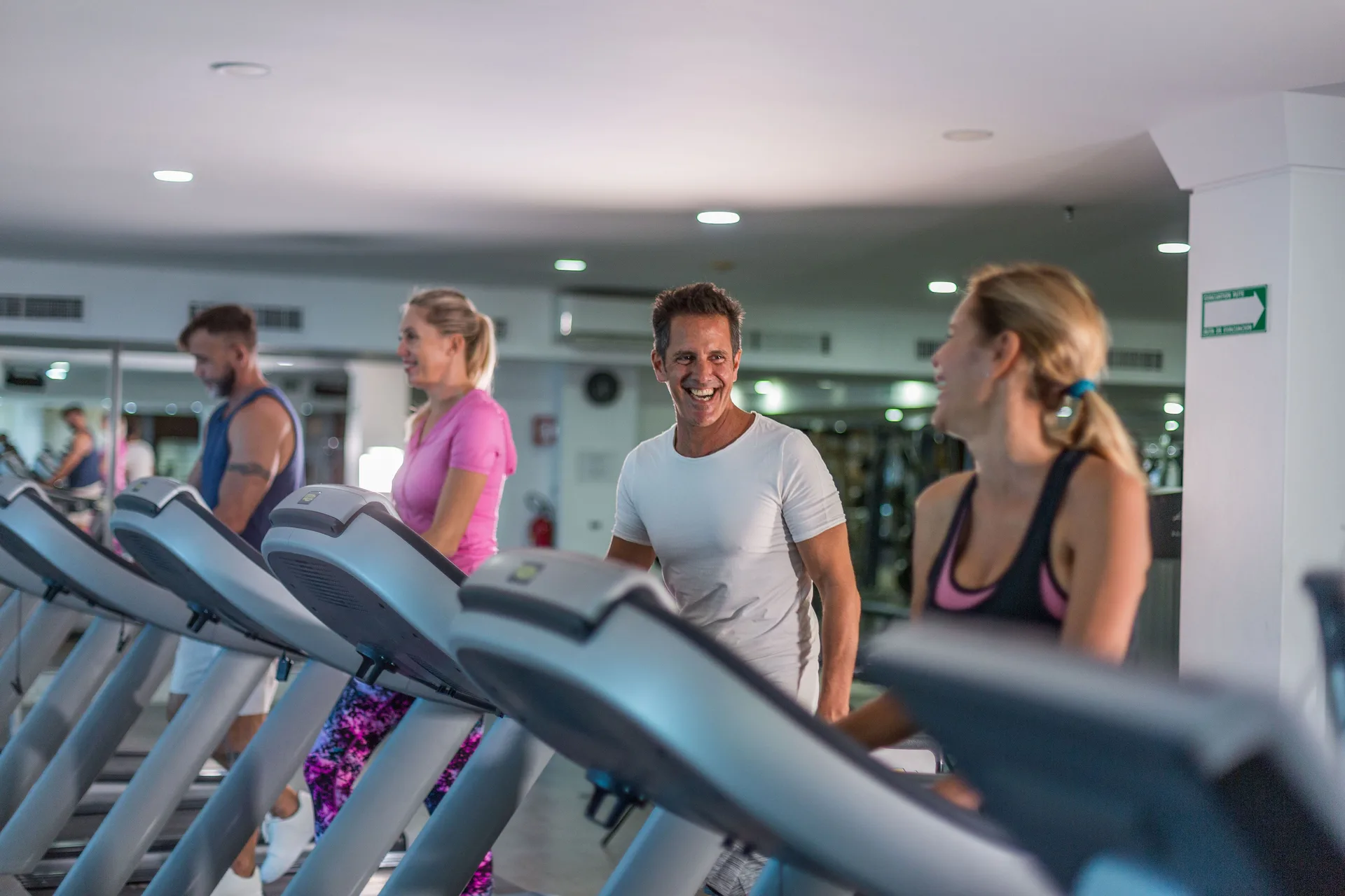 Guests use treadmills together inside the fitness center at Sandos Cancún.