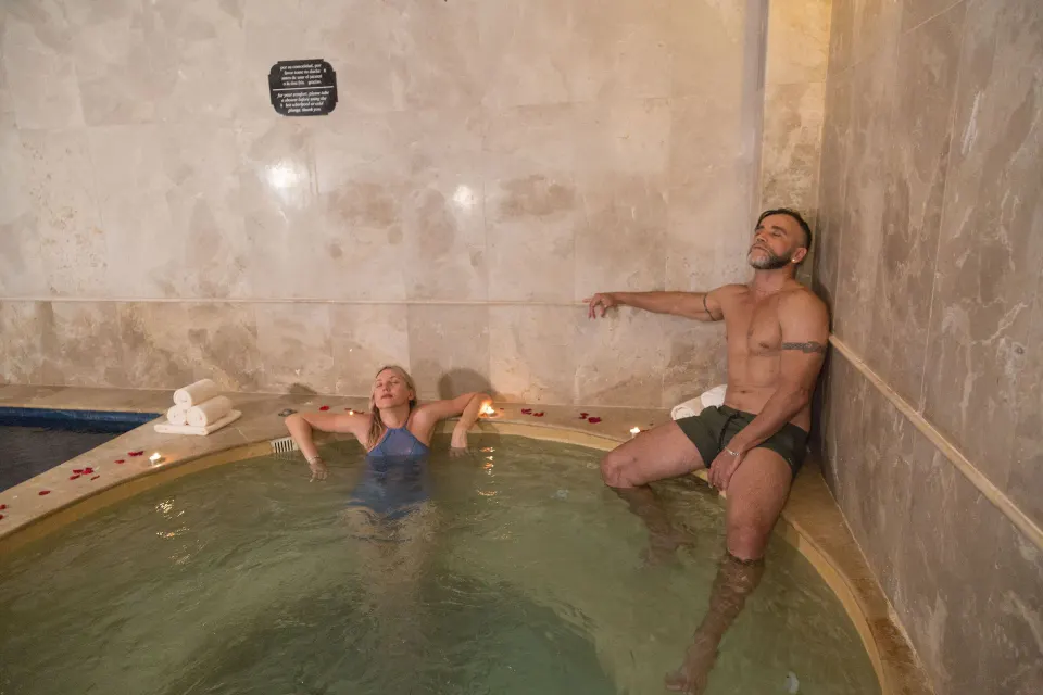 Guests relax in an indoor spa hydrotherapy pool at Sandos Cancún.