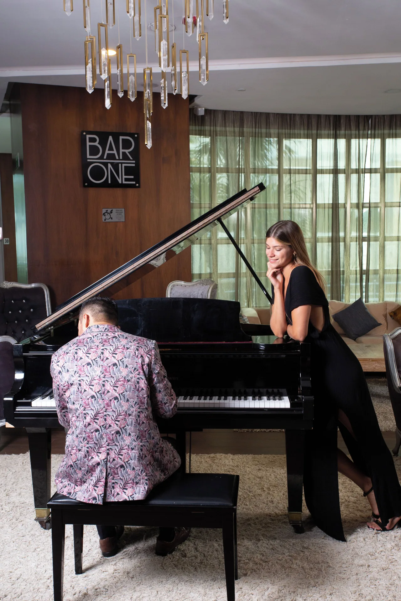 A pianist performs beside the Bar One sign at Sandos Cancún.