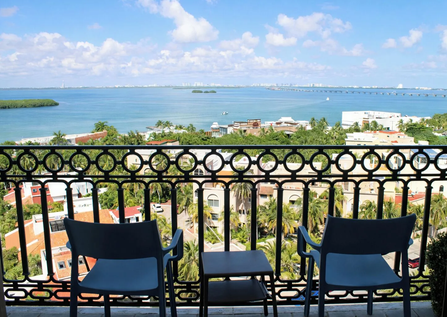 Laguna Suite balcony seating with lagoon view at Sandos Cancún.