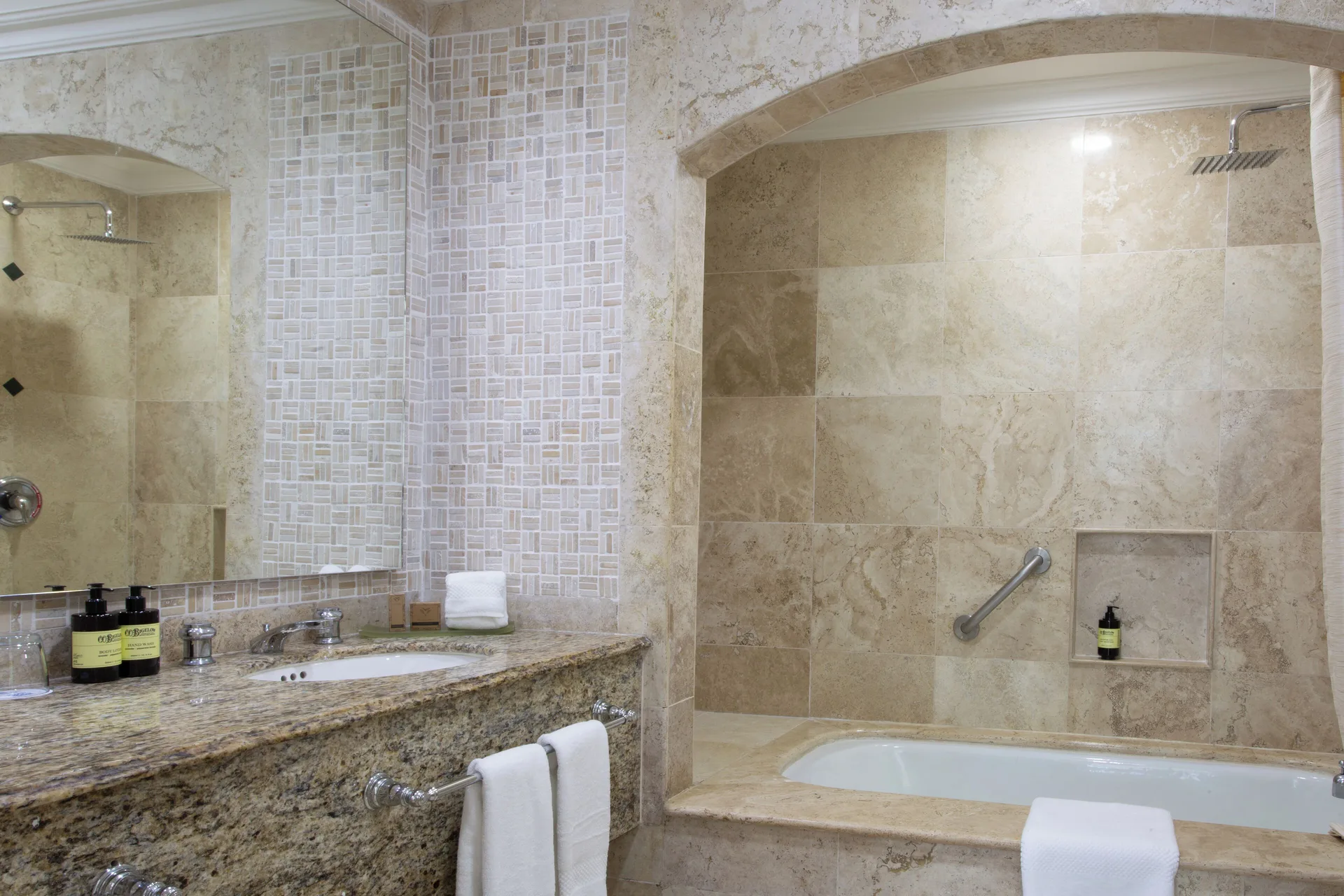 Sandos Cancún bathroom with vanity, mirror, soaking tub, and walk-in shower at Sandos Cancún.