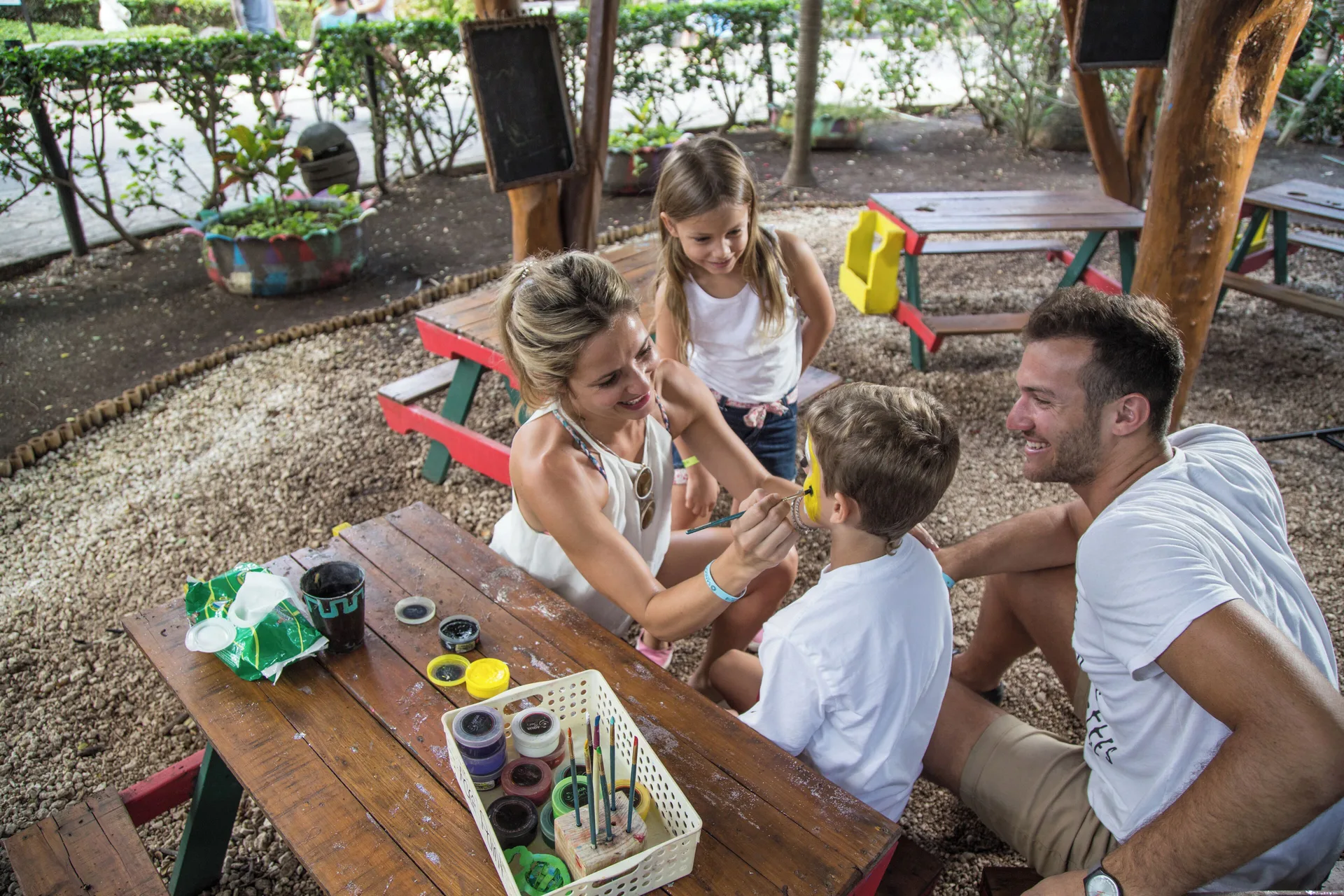A child gets face paint during a family activity at Sandos Caracol Nature Resort & Water Park.