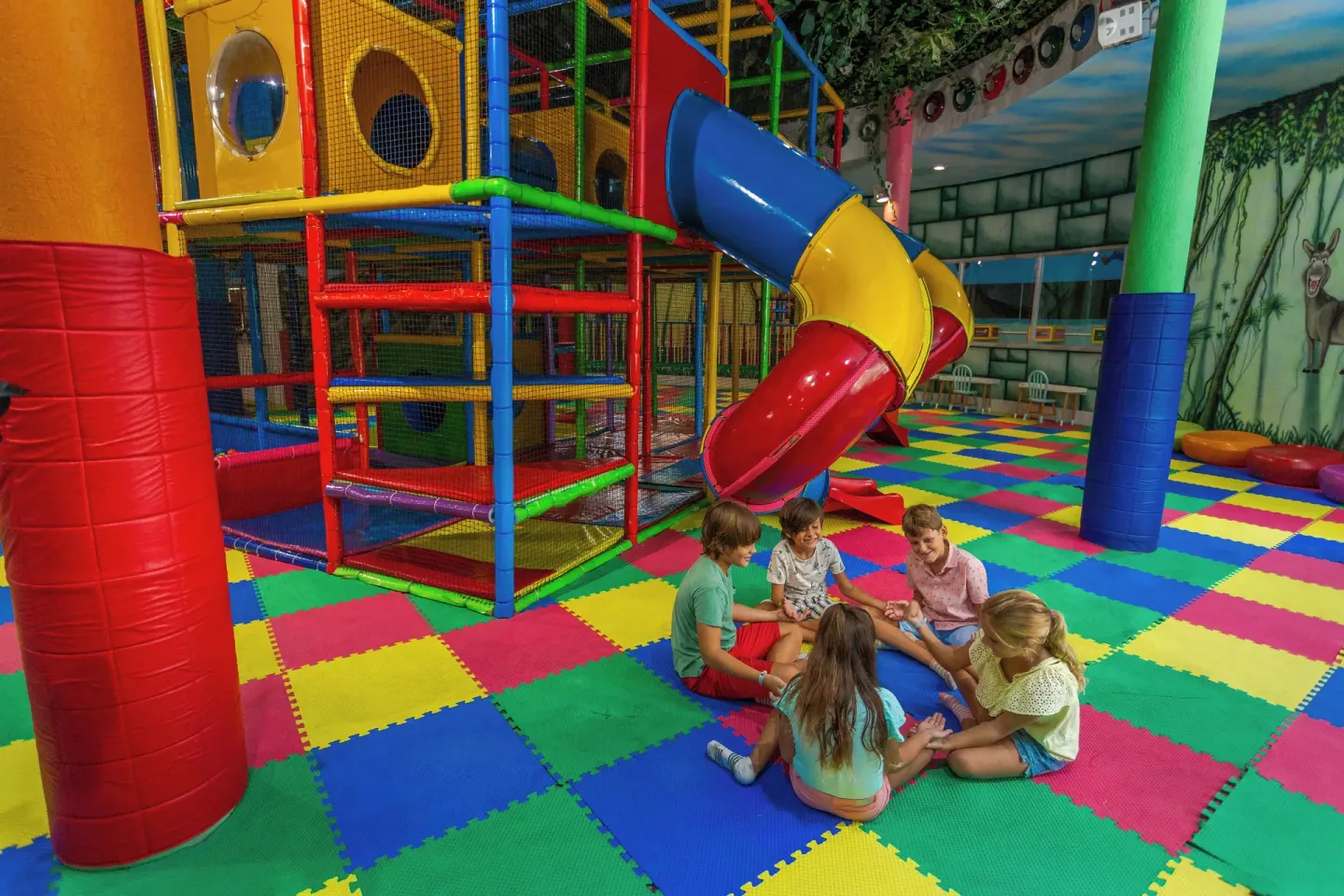 Colorful indoor play area with slide at Sandos Caracol Nature Resort & Water Park.