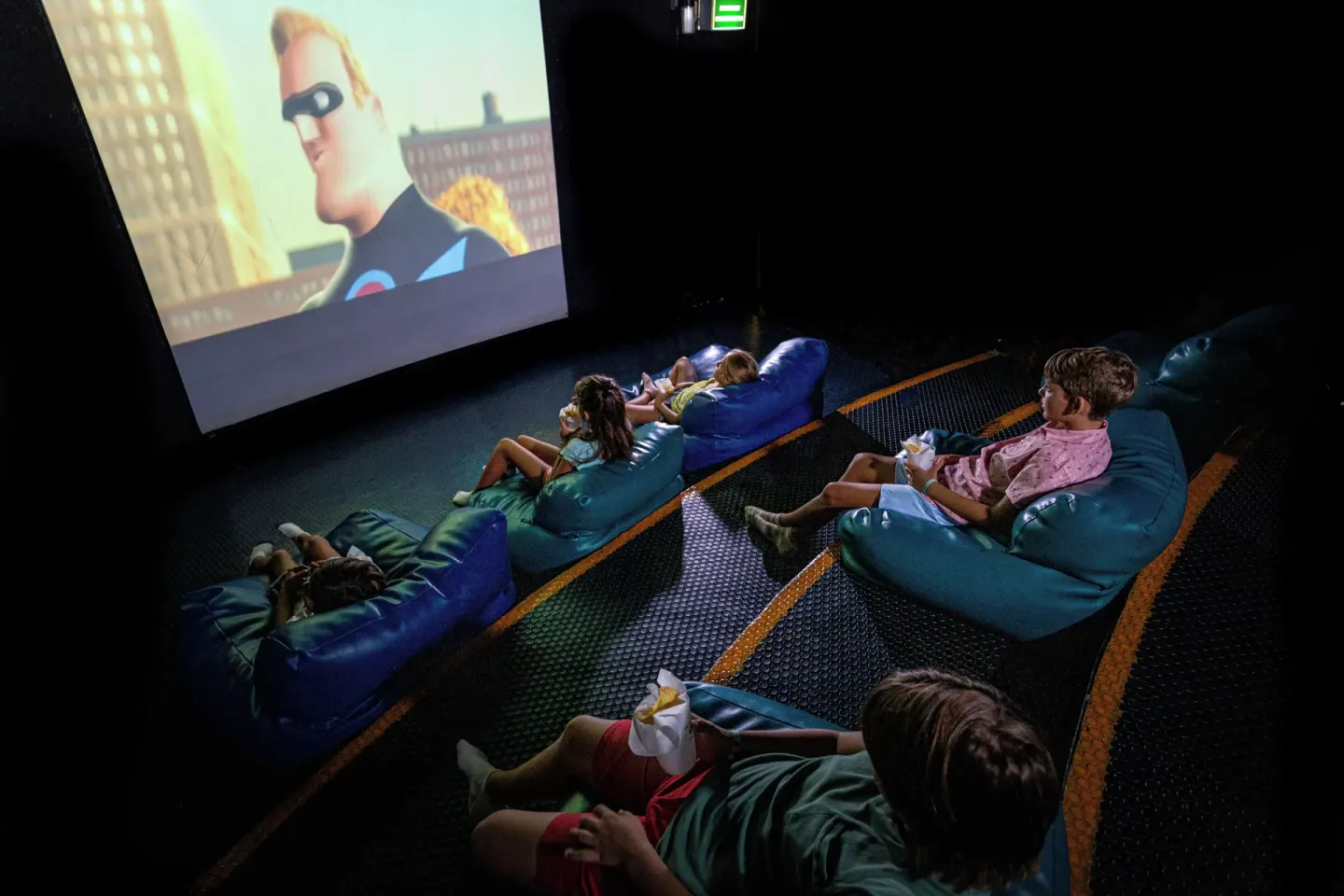 Children watching a movie on beanbags at Sandos Caracol Nature Resort & Water Park.