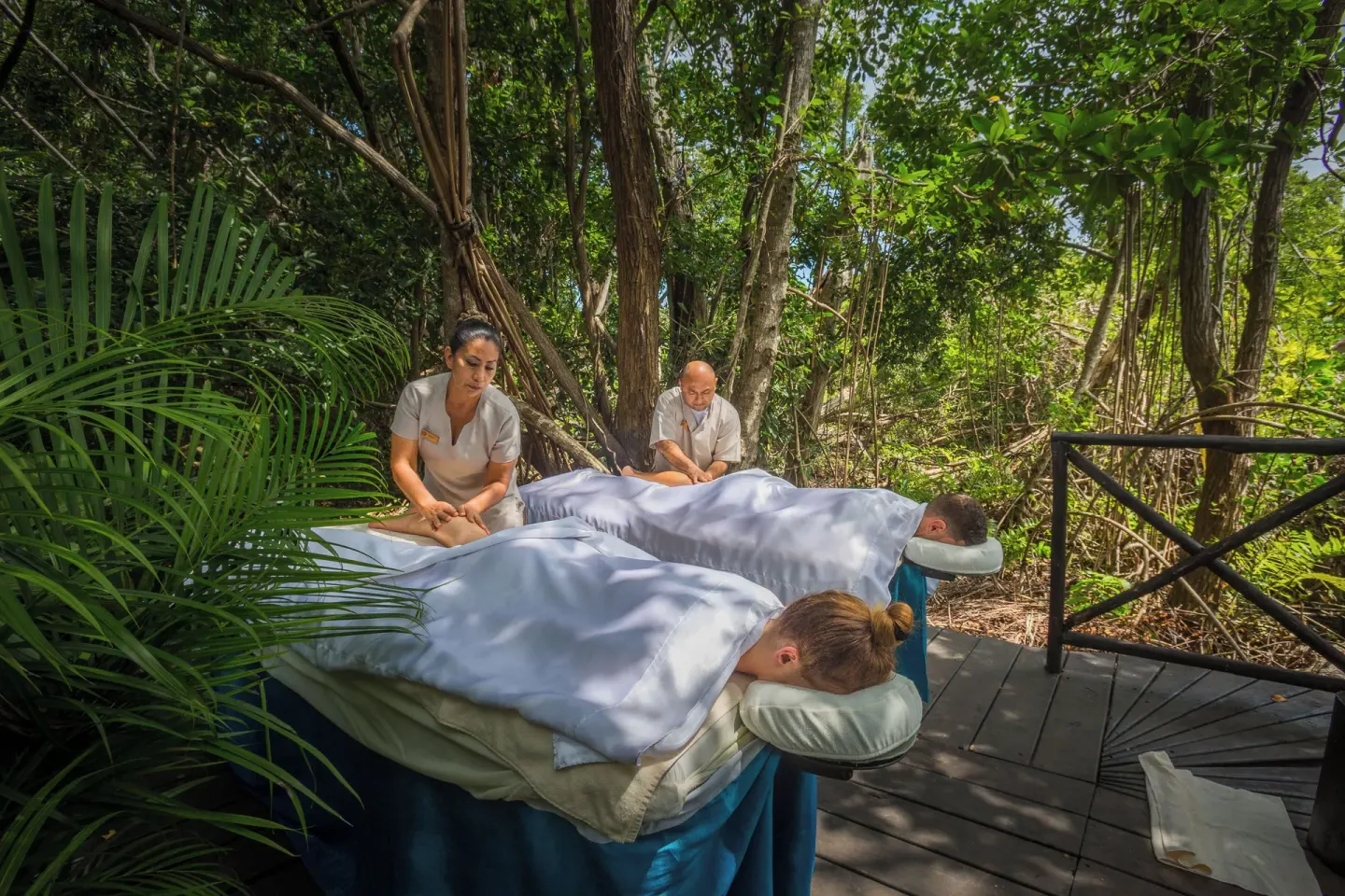 Outdoor couples massage in the trees at Sandos Caracol Nature Resort & Water Park.