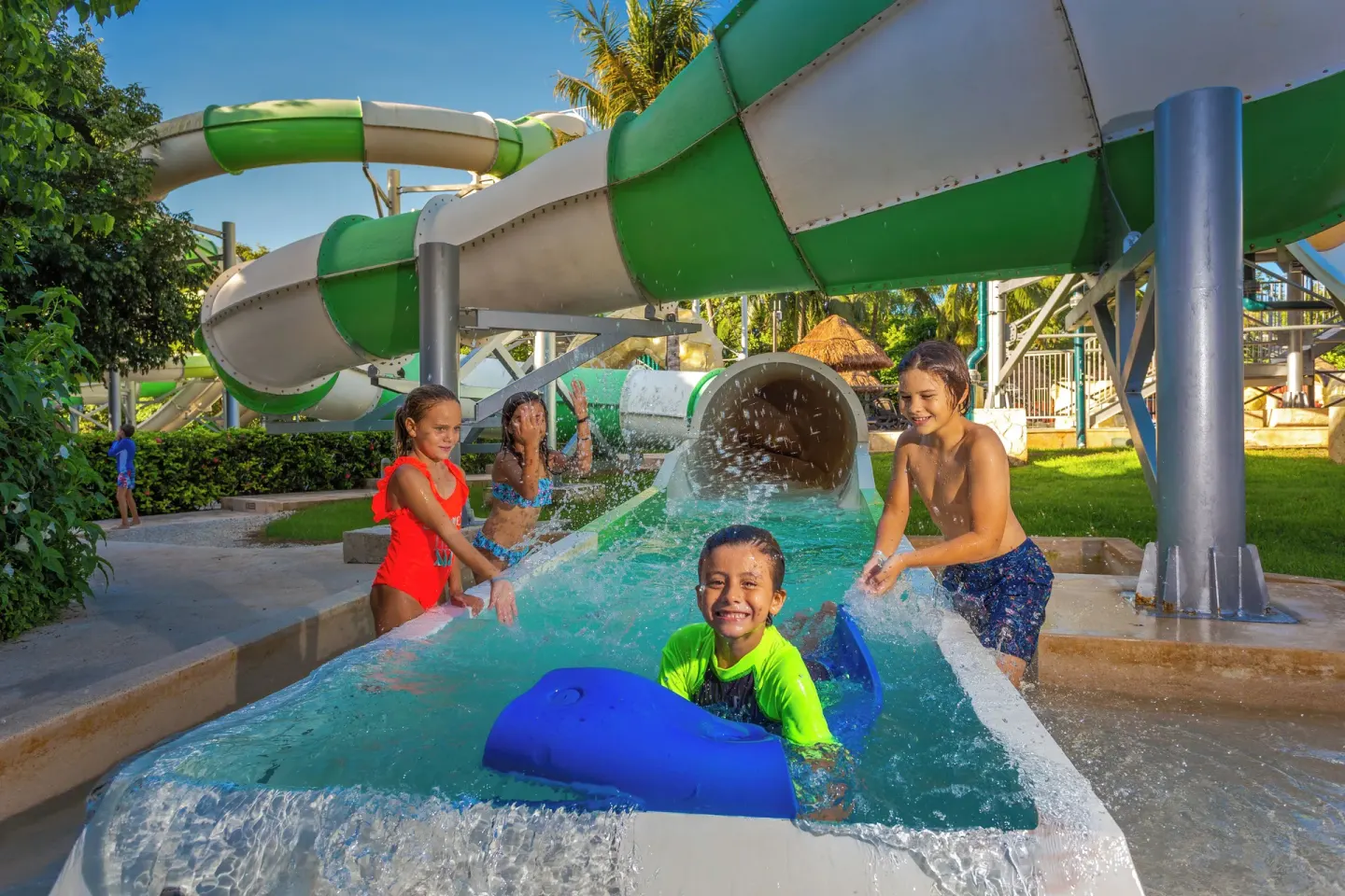 Children play in a slide runout at Sandos Caracol Nature Resort & Water Park.