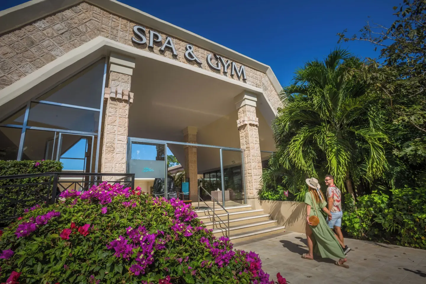 Spa and gym entrance with tropical landscaping at Sandos Caracol Nature Resort & Water Park.