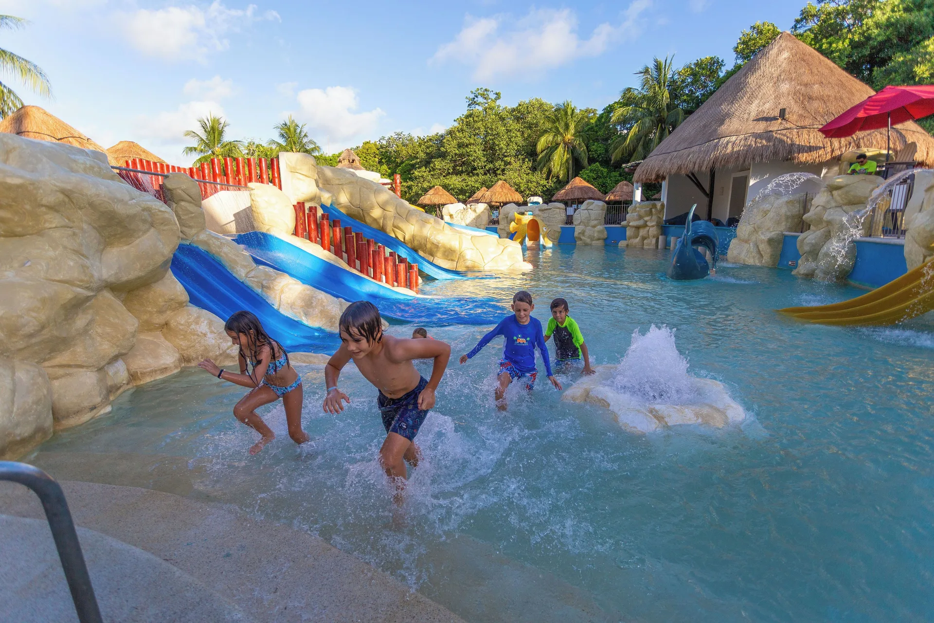 Children splash in the water park play pool at Sandos Caracol Nature Resort & Water Park.