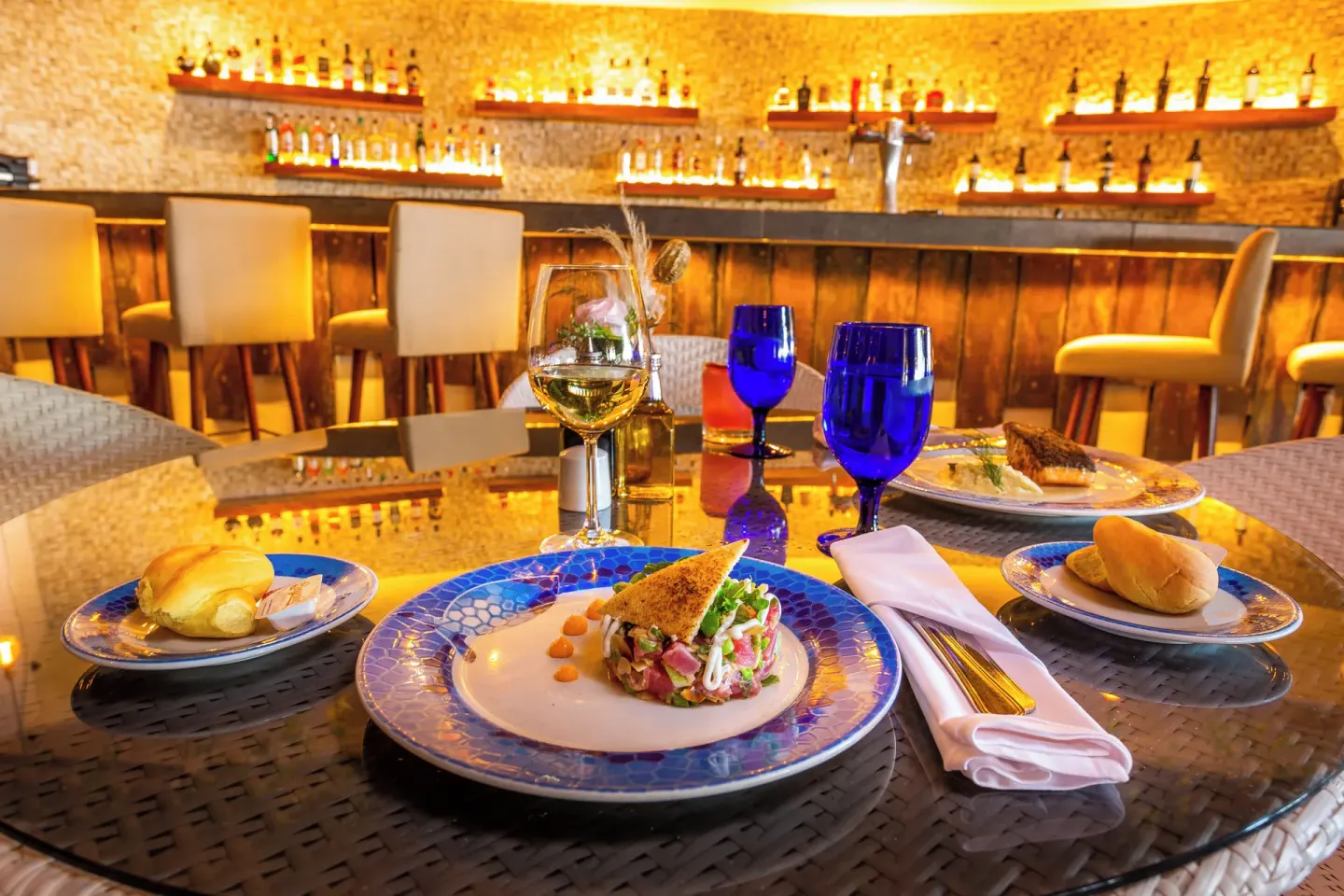 Plated appetizer and drinks in a bar at Sandos Caracol Nature Resort & Water Park.