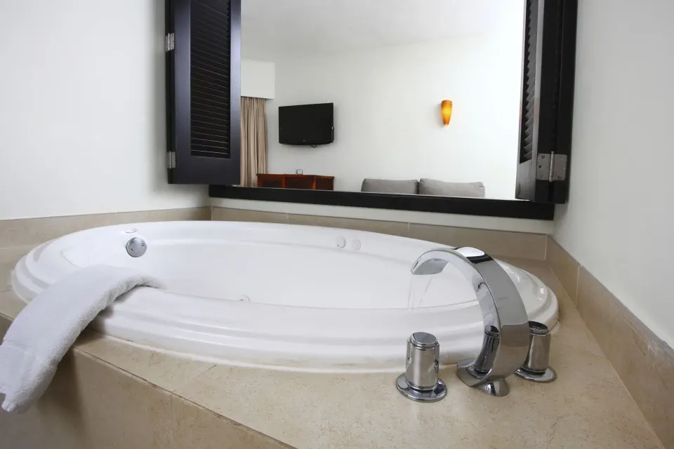 In-room whirlpool tub in a Deluxe Select room at Sandos Caracol Nature Resort & Water Park.