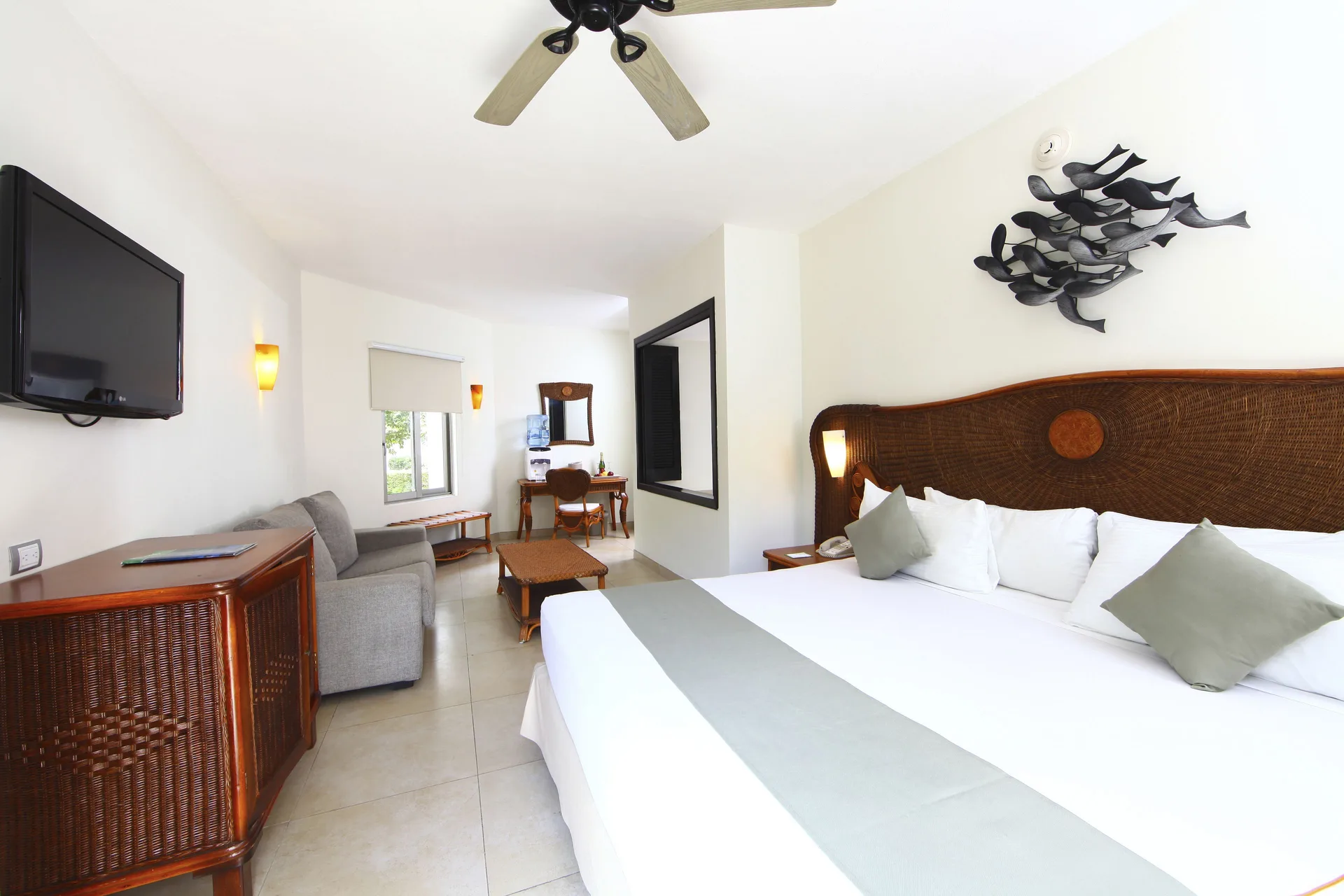 Deluxe Select adults-only king room with sitting area at Sandos Caracol Nature Resort & Water Park.
