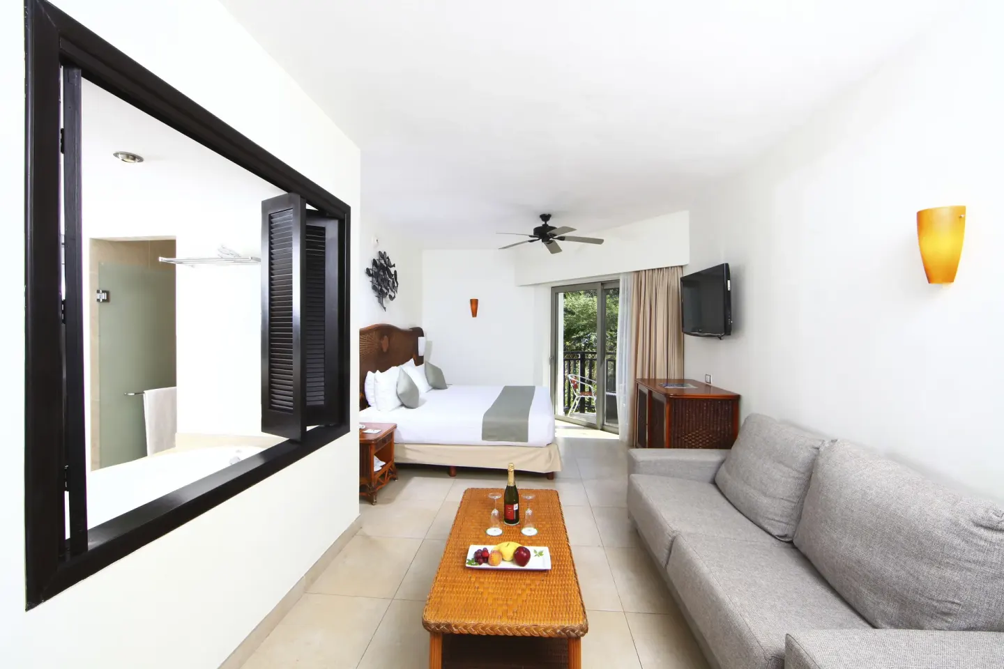Deluxe Select adults-only room with king bed and sofa at Sandos Caracol Nature Resort & Water Park.